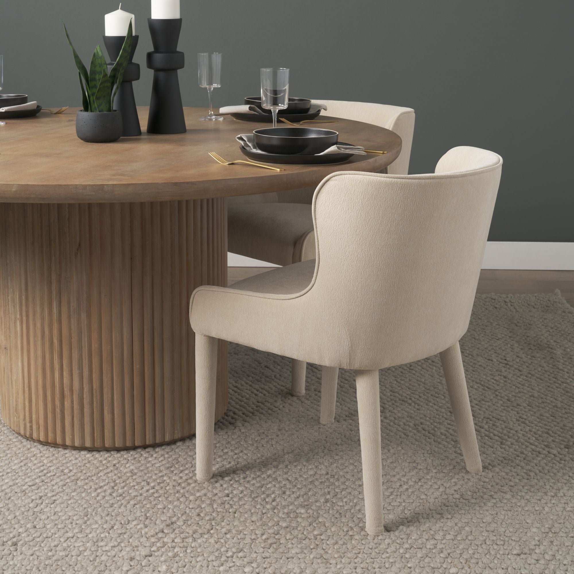Mercana Furniture Nolan dining chair in cream chenille fabric with a sleek, modern design and wooden legs.