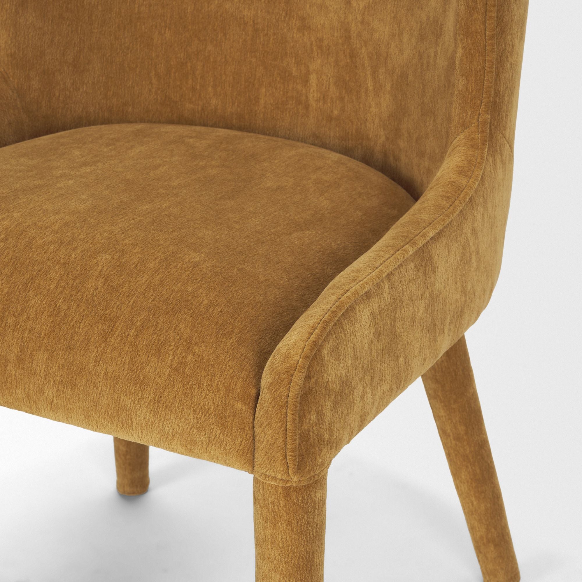 Cream chenille Nolan dining chair by Mercana Furniture with wooden legs, shown in a modern dining room setting.