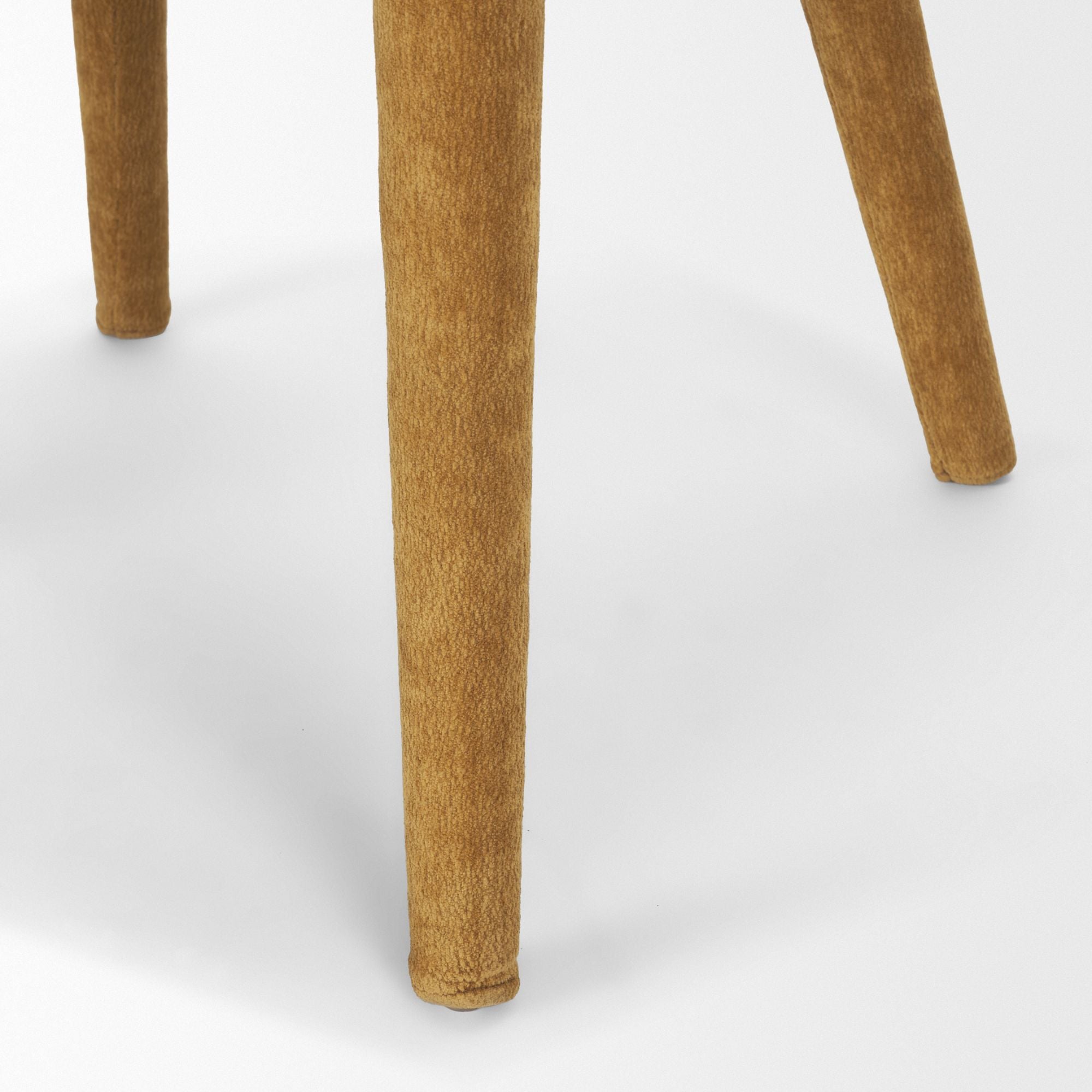 Cream chenille Nolan dining chair by Mercana Furniture with upholstered seat and wooden legs, shown in a modern dining setting.