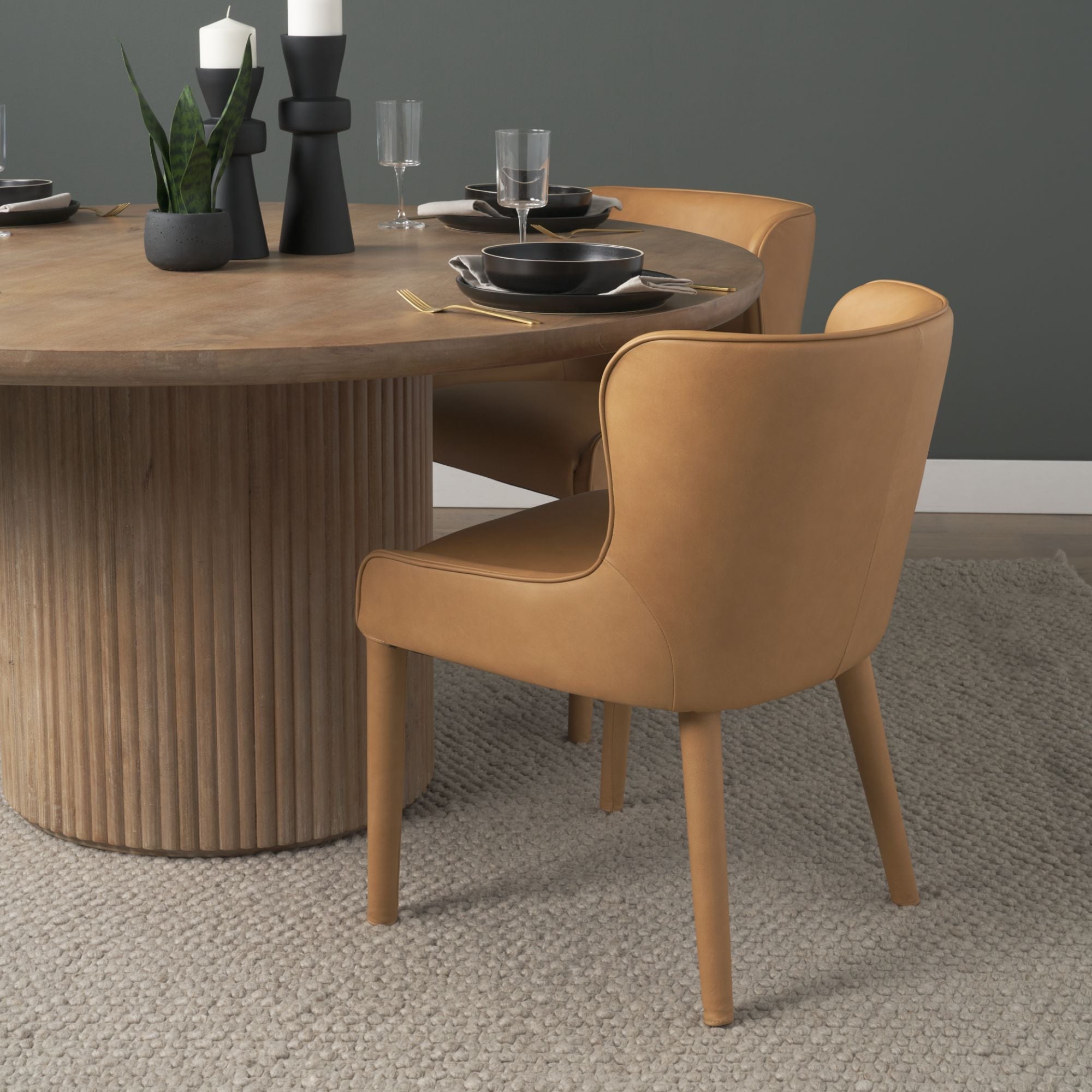 Mercana Furniture Nolan leather dining chair with sleek design and padded seat, perfect for modern dining rooms.