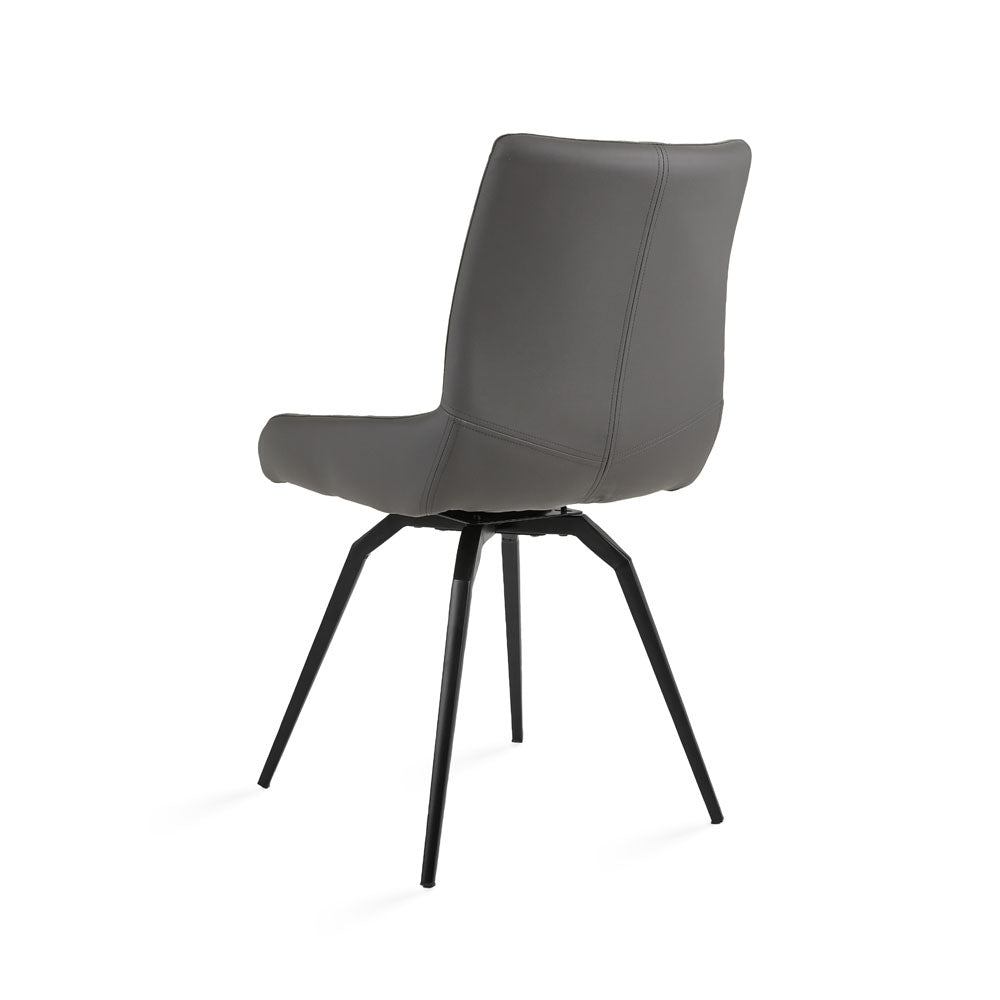 Pair of Xcella Nona swivel dining chairs with grey faux leather upholstery and modern Norman-back design.