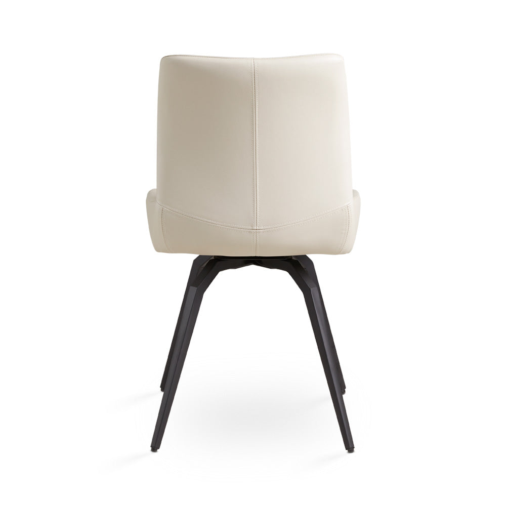 Two Xcella Nona swivel dining chairs with modern design and wooden legs, shown from a side angle in a contemporary dining room.