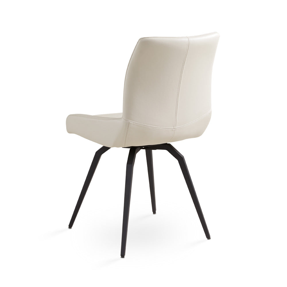 Pair of Xcella Nona swivel dining chairs with cushioned seats and modern design, shown in a contemporary dining room setting.