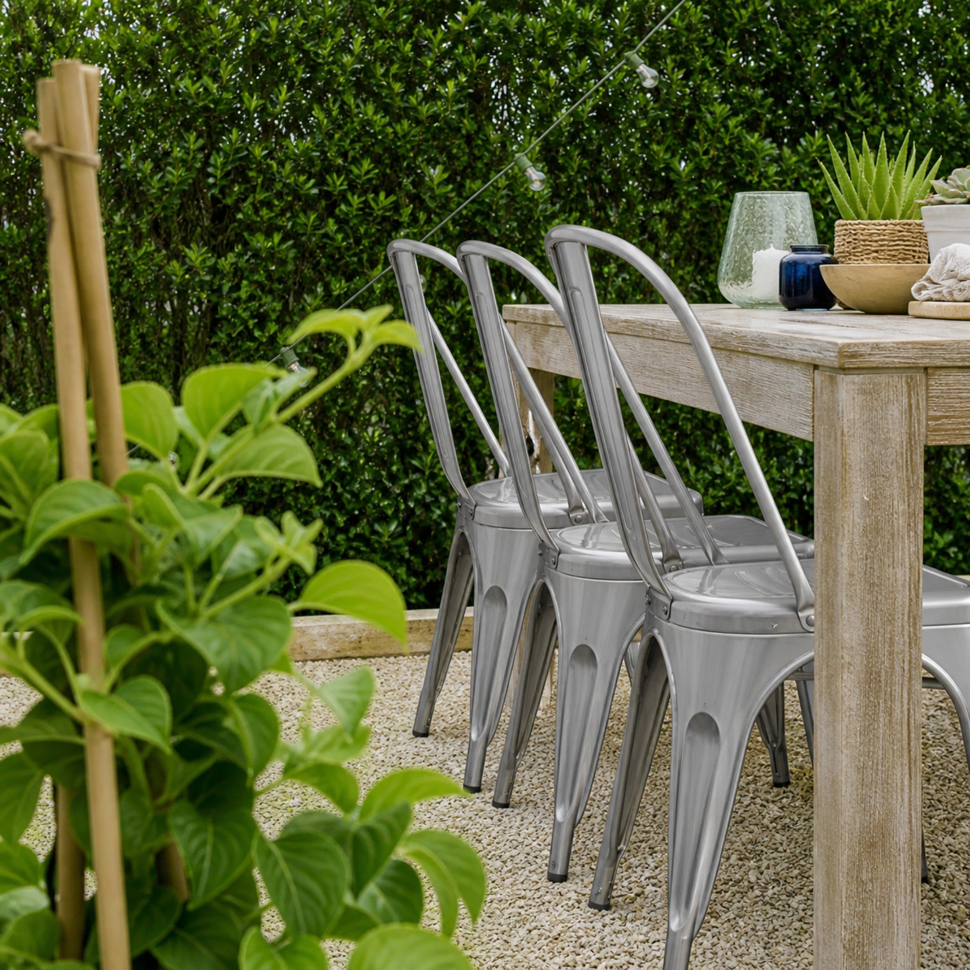 Set of two Elite Living Rochelle stackable dining chairs in gun steel finish, ideal for outdoor dining with sleek metal design.