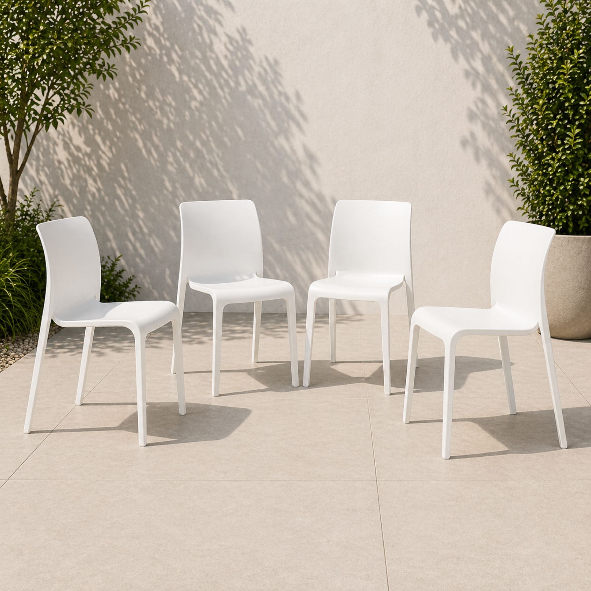Set of four white Faro stackable dining chairs by Elite Living, outdoor furniture with sleek, modern design.
