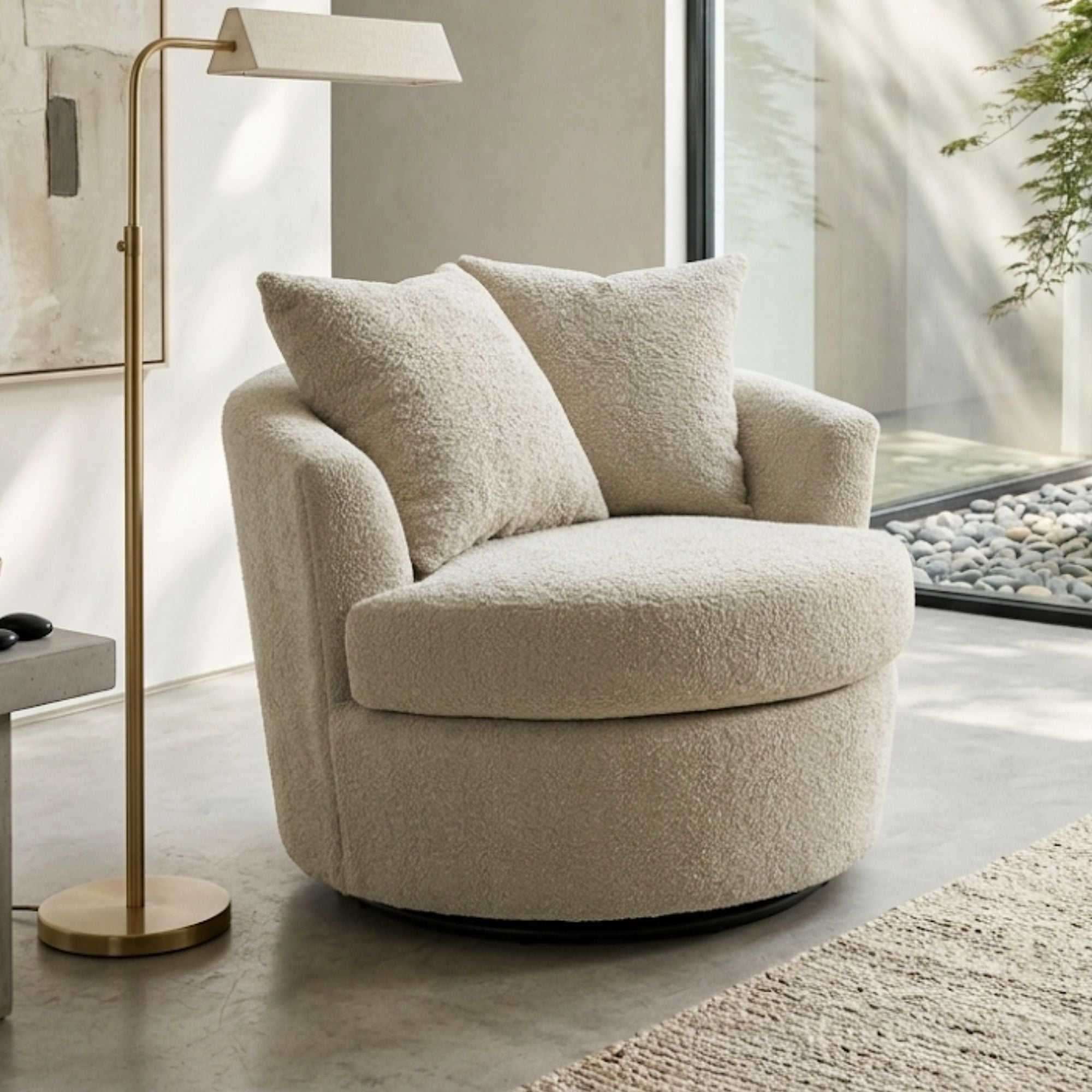 A beige oversized bouclé fabric swivel chair by A.C., showcasing a plush, textured upholstery and modern design.