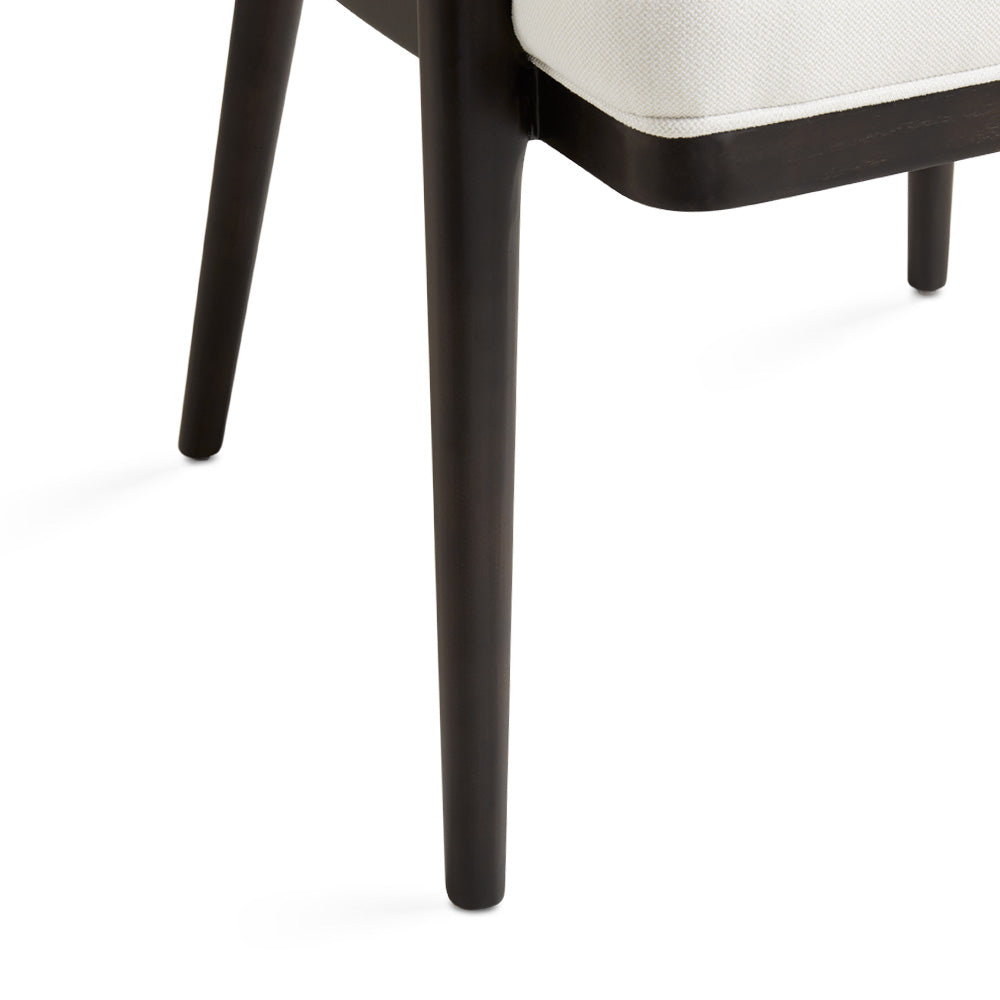 White Erica dining chair by Xcella with wooden legs, suitable for kitchen and dining room settings.