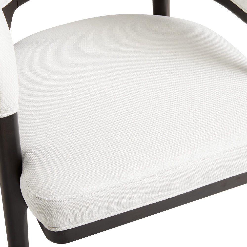 White Erica dining chair by Xcella, featuring a sleek modern design, shown from a side angle in a kitchen or dining room setting.
