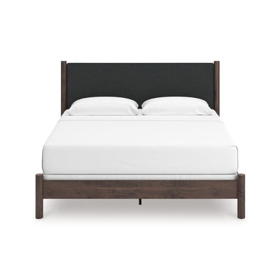 Pamytta upholstered panel platform bed by Signature Ashley with a modern upholstered headboard in a bedroom setting.