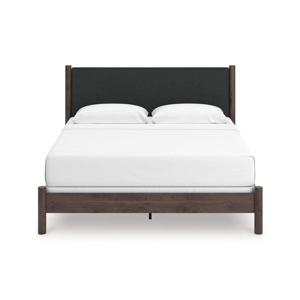 Pamytta upholstered panel platform bed by Signature Ashley with a modern upholstered headboard in a bedroom setting.
