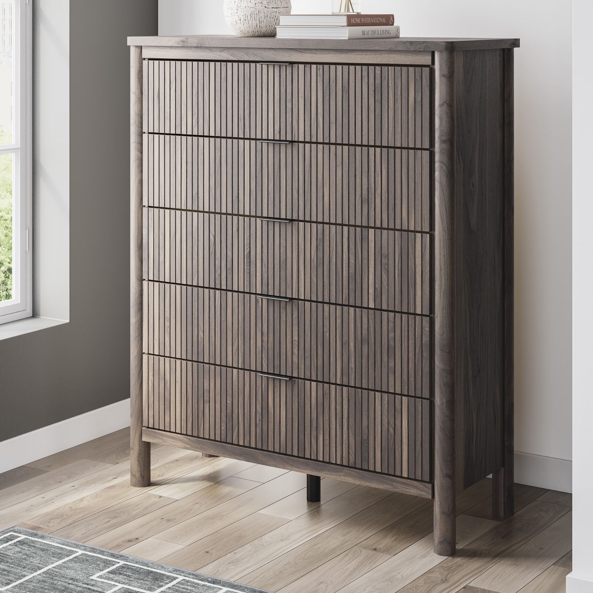 Brown Pamytta five-drawer wide chest by Signature Ashley, featuring a sturdy wooden design with sleek handles for bedroom storage.