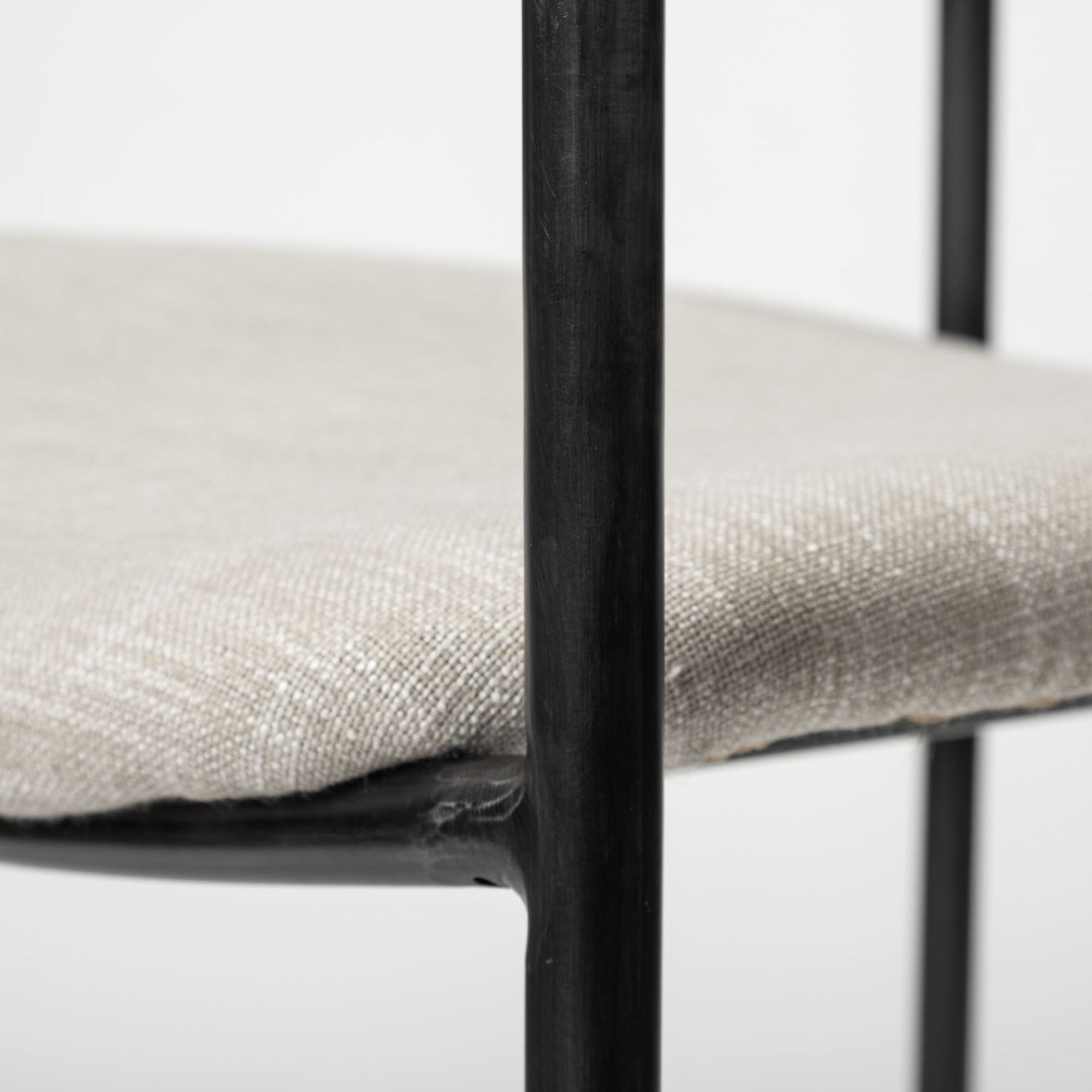 Beige Parker dining chair by Mercana Furniture with cushioned seat and wooden legs, ideal for modern dining rooms.