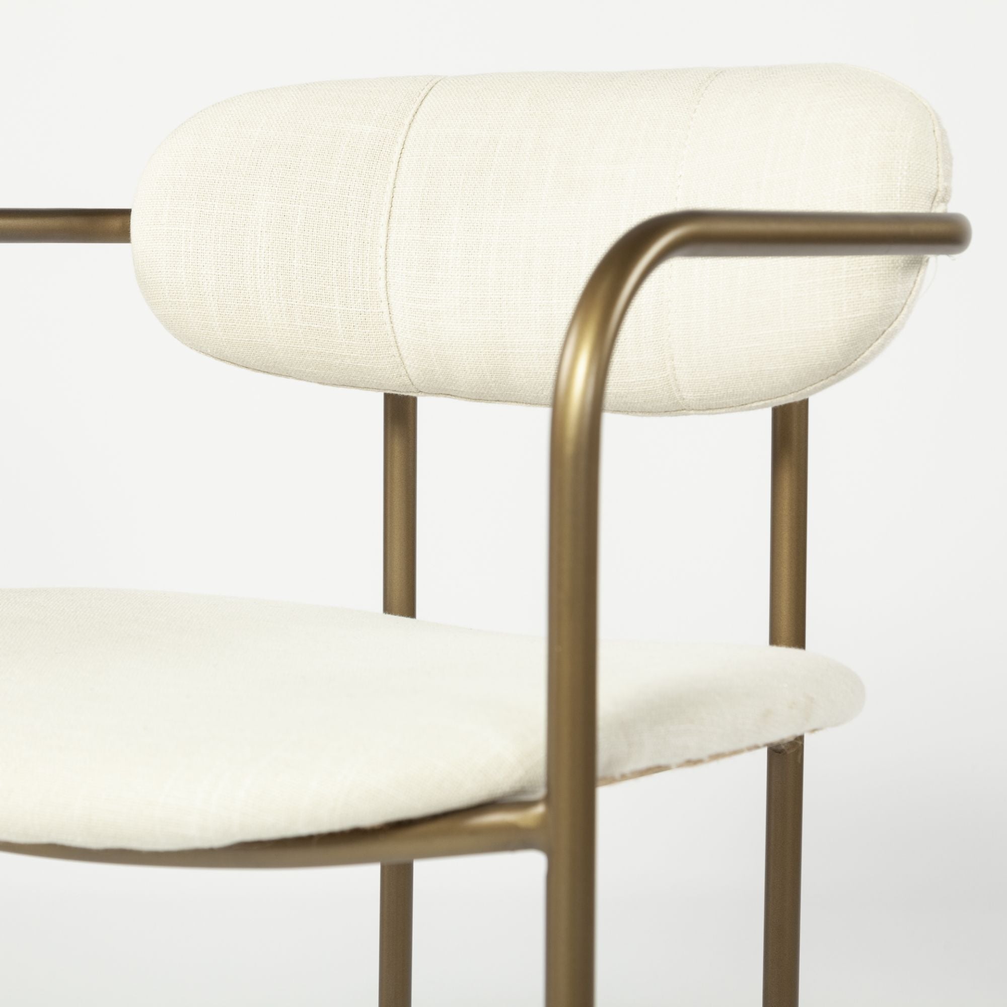 Cream Parker dining chair by Mercana Furniture, featuring a sleek, modern design with a comfortable upholstered seat and wooden legs.