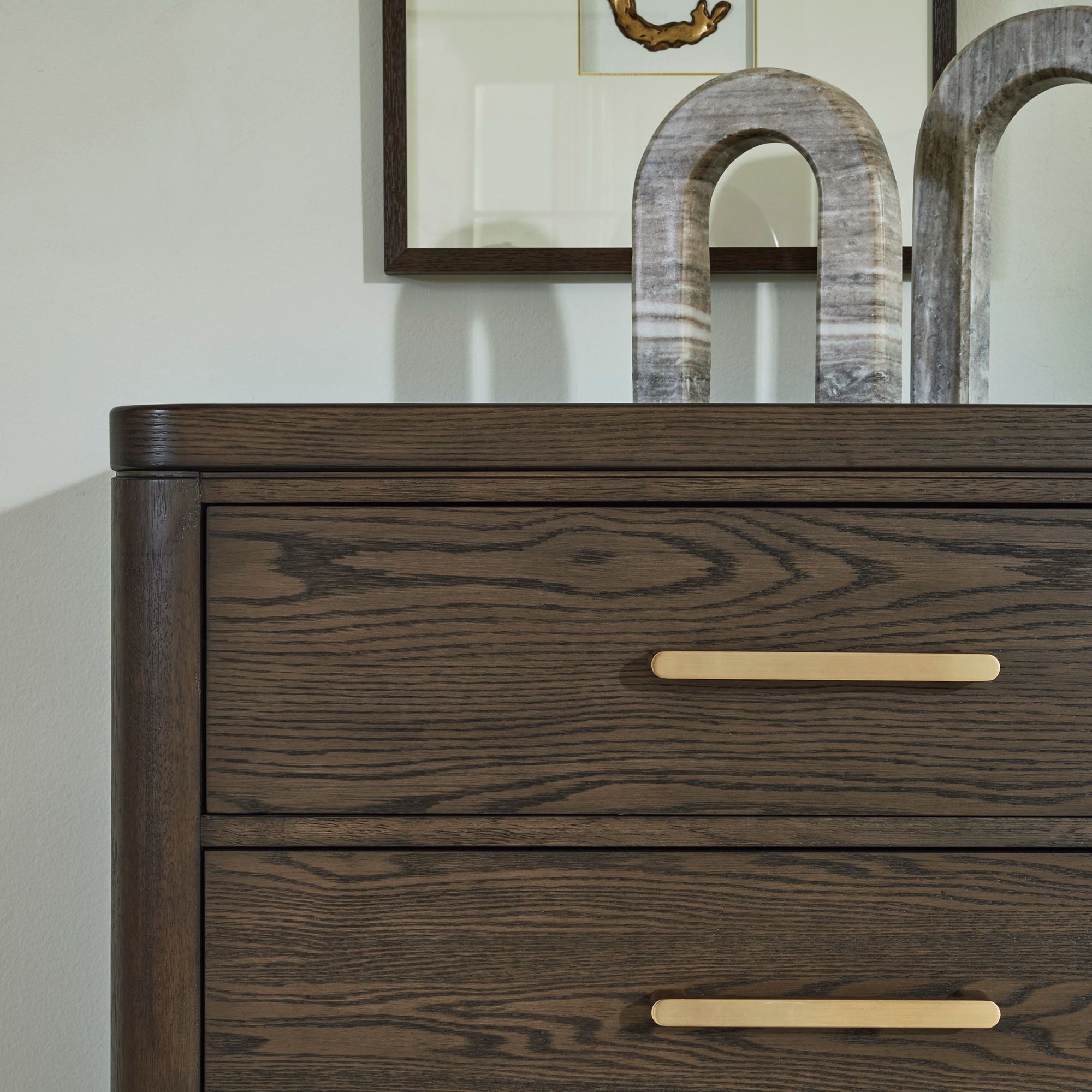 Signature Design by Ashley Radkin five-drawer chest with dark wood finish, featuring sleek handles and clean modern design.