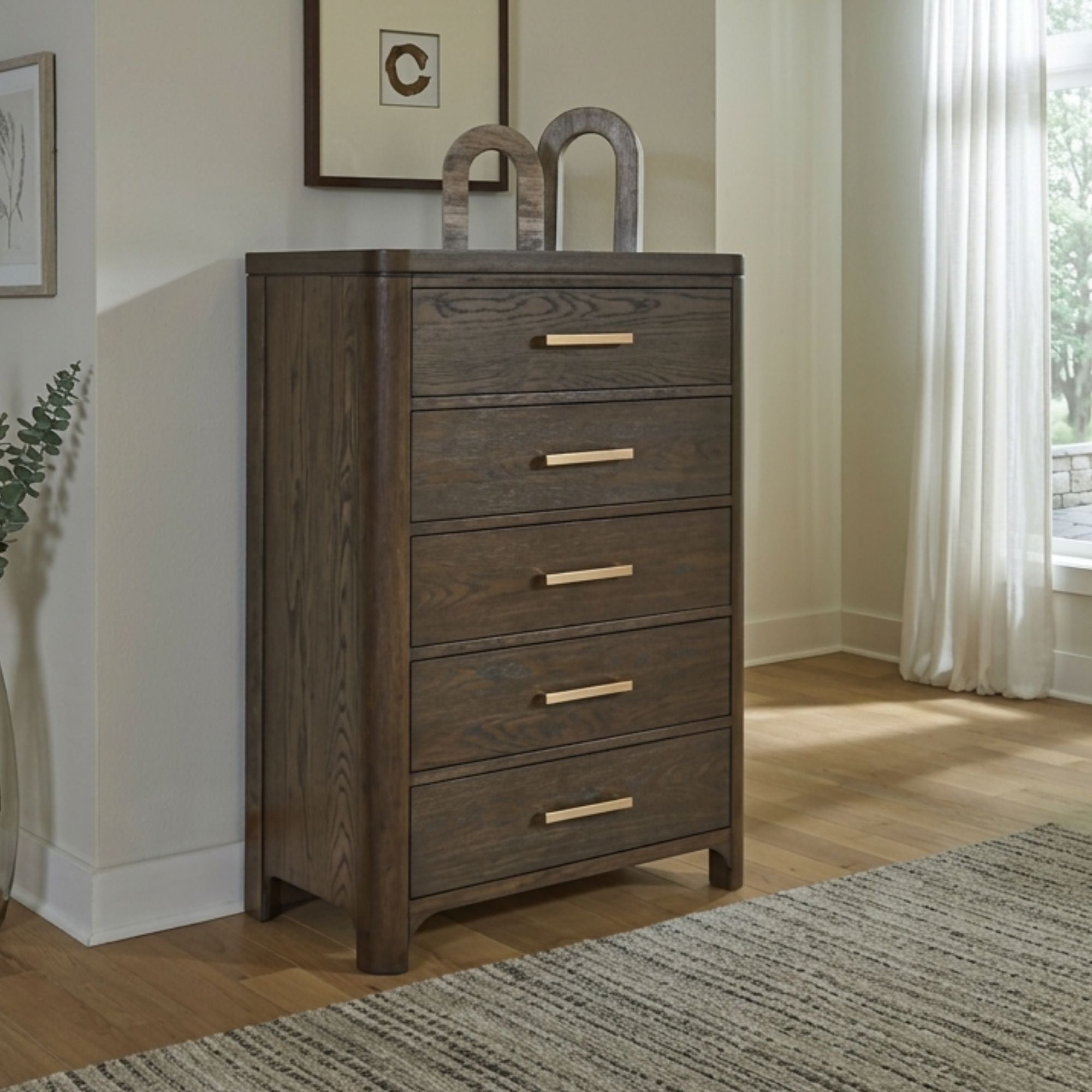 Radkin five-drawer chest from Signature Design by Ashley, showing a stylish bedroom storage solution with dark wood finish.