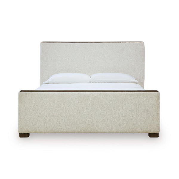 Radkin upholstered panel bed from Signature Design by Ashley showing a modern bed with a padded headboard and neutral fabric upholstery.