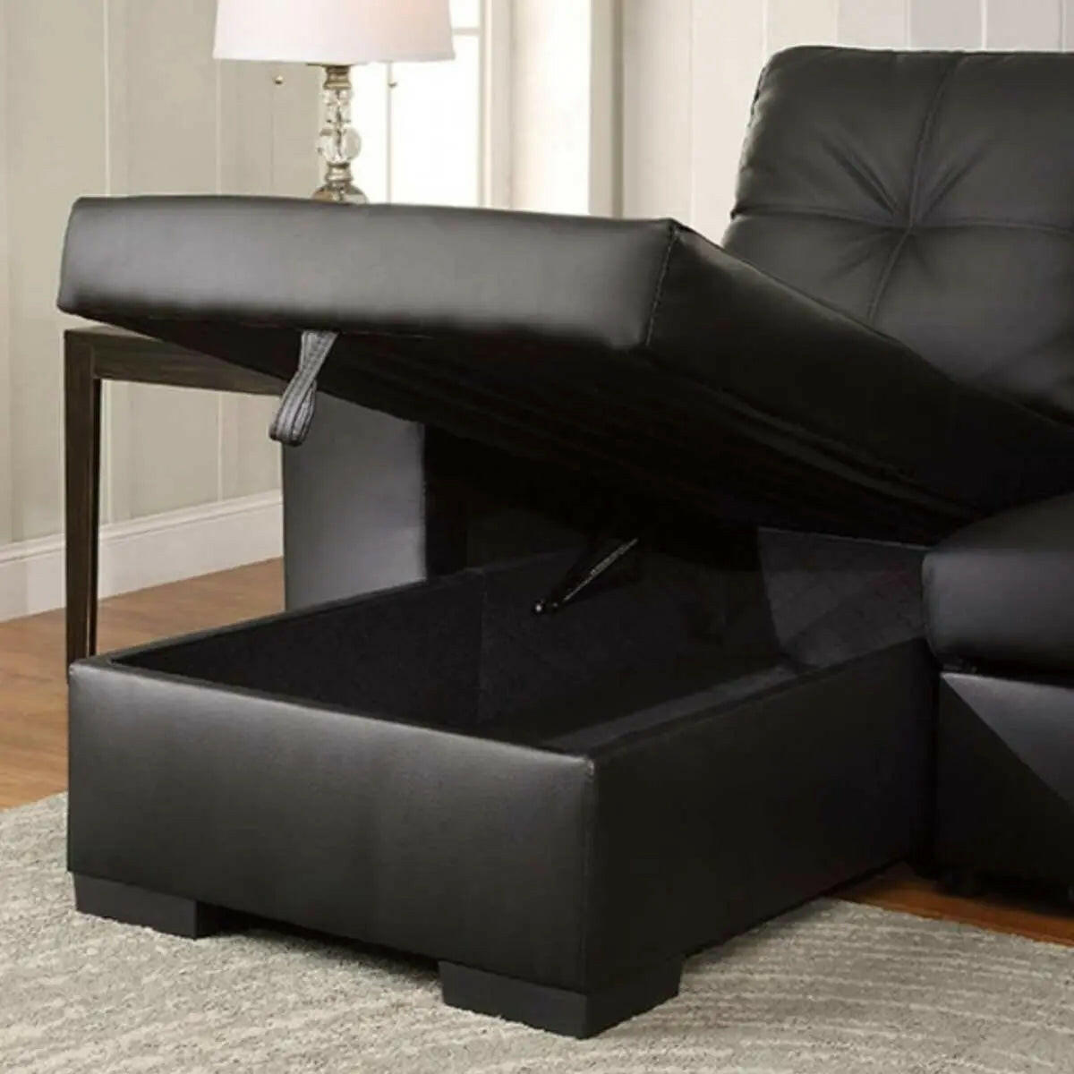Black PU reversible sectional sleeper sofa with storage chaise by IFF, featuring modern design and convertible sleeping space.