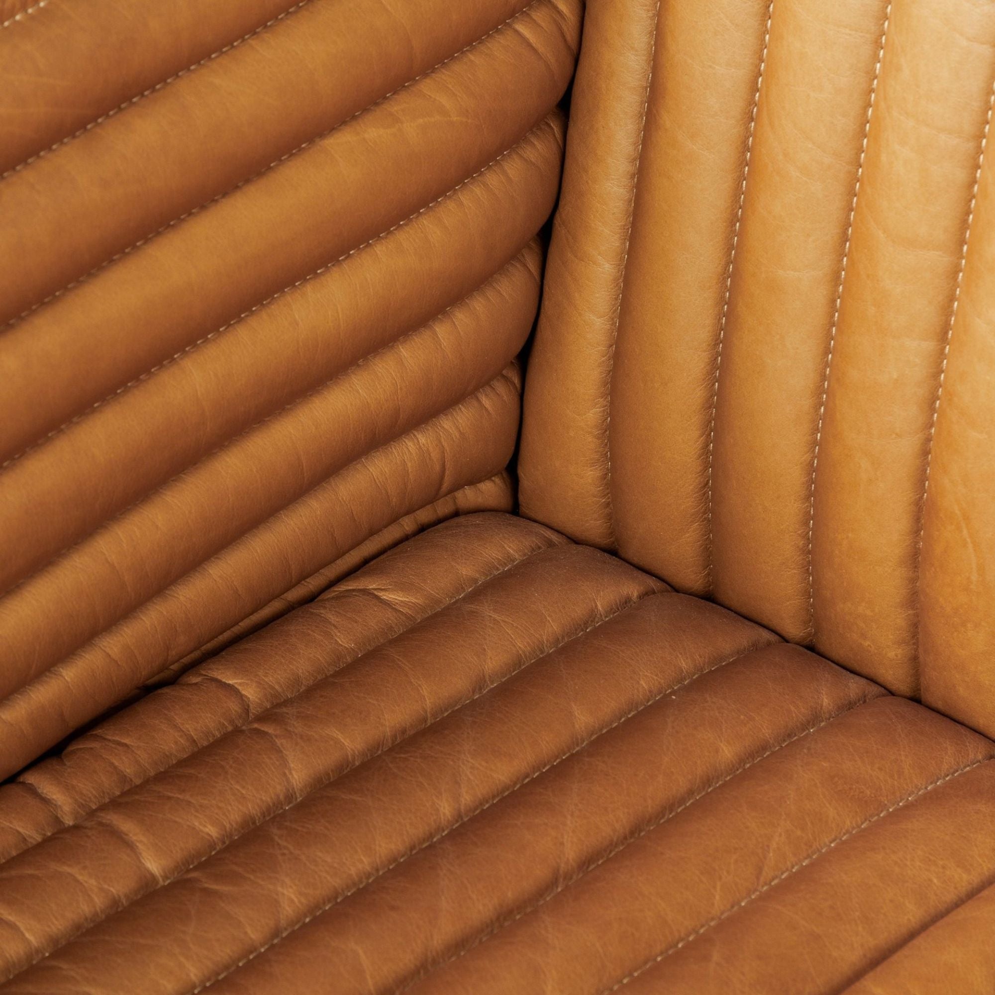Mercana Ricciardo 82.5-inch cognac leather three-seater sofa with plush cushions and sleek black legs