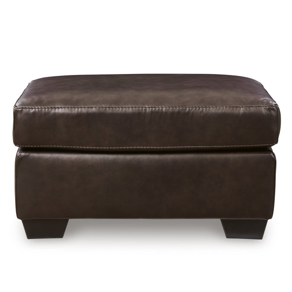 Dark brown Santorine leather ottoman by Signature Design Ashley, featuring a plush cushioned top and sleek wooden legs.