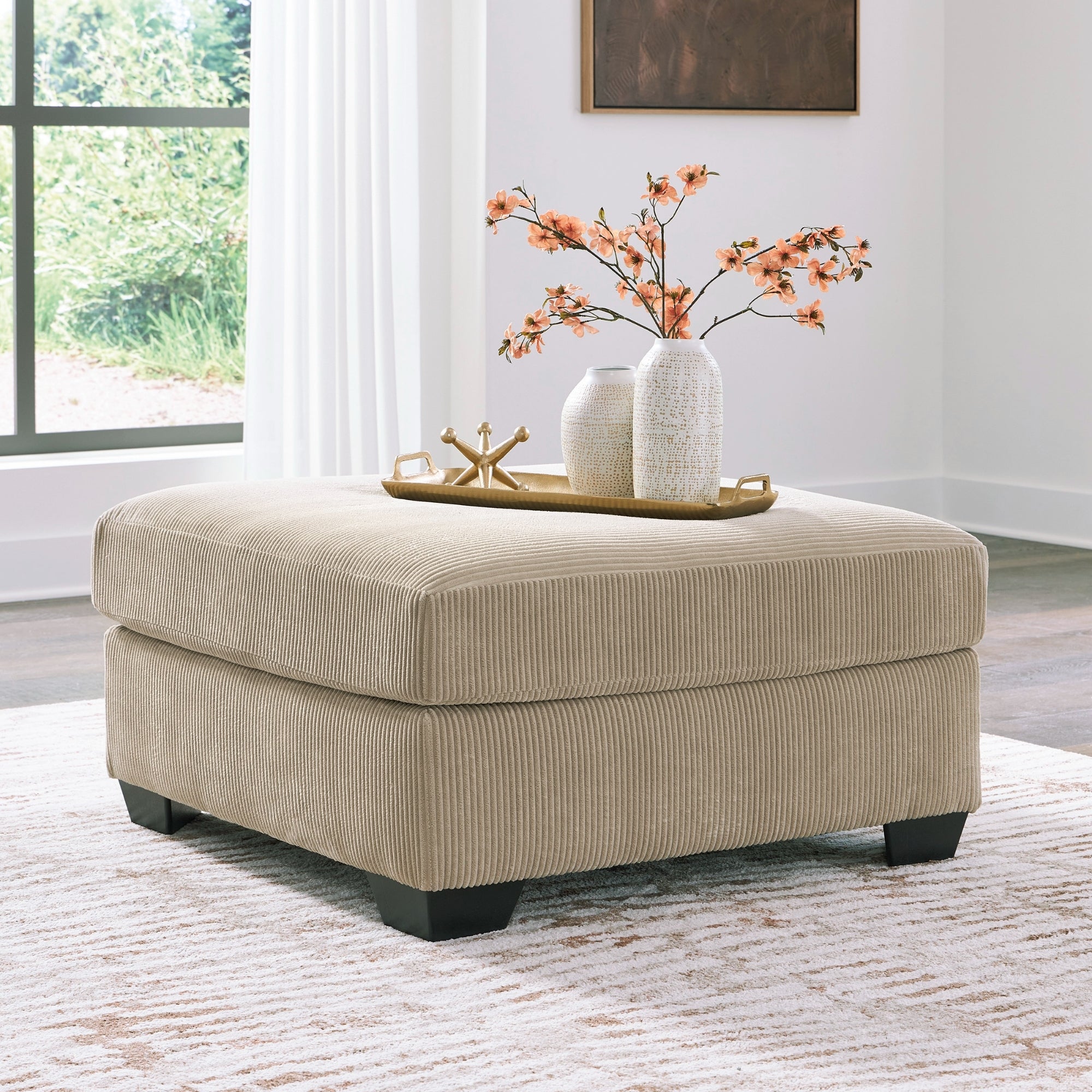 SimpleJoy oversized accent ottoman in sand, Signature Design by Ashley, showing a plush, textured fabric with a rectangular shape.
