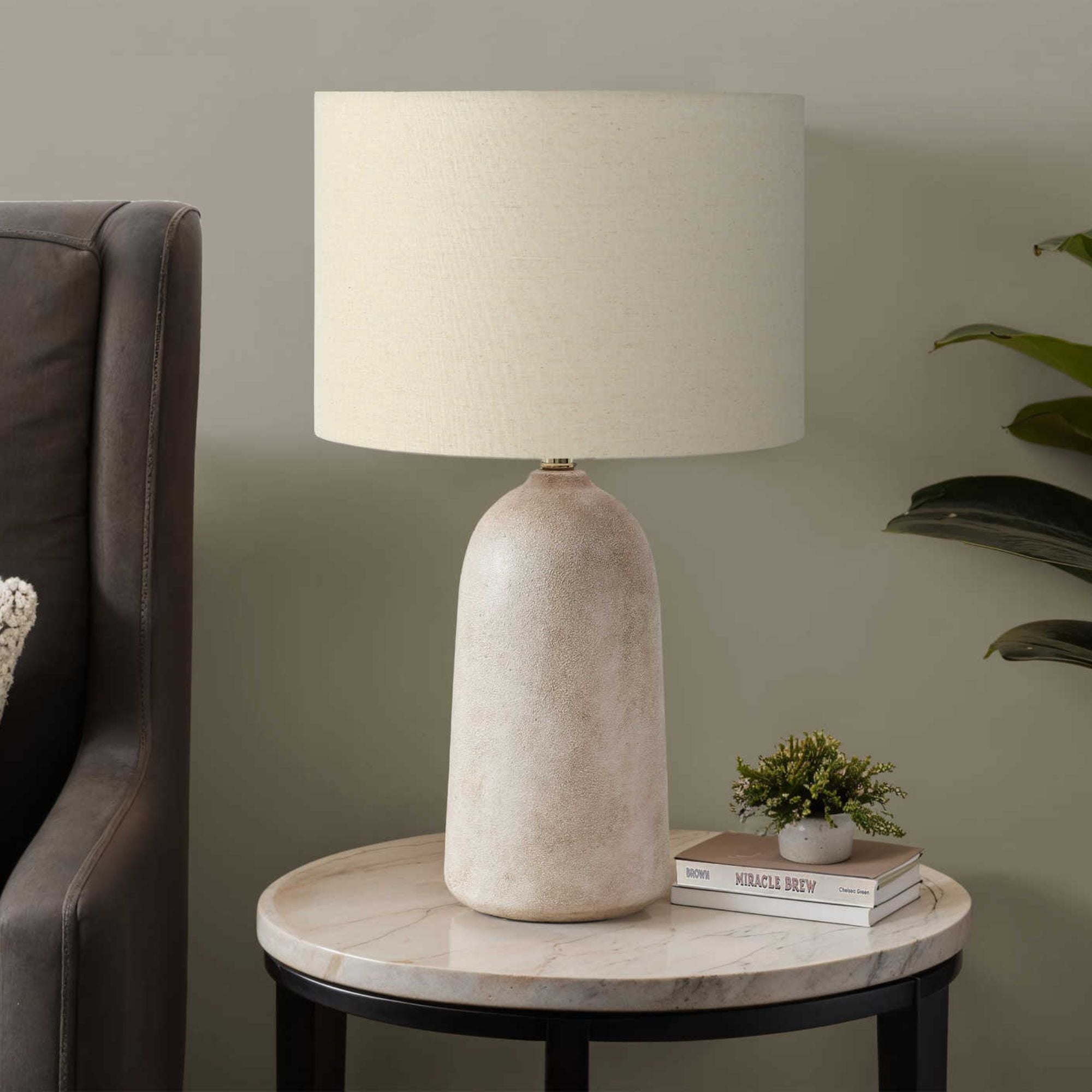 Beige ceramic table lamp measuring 27 inches tall with a classic design, perfect for living room or bedroom decor.