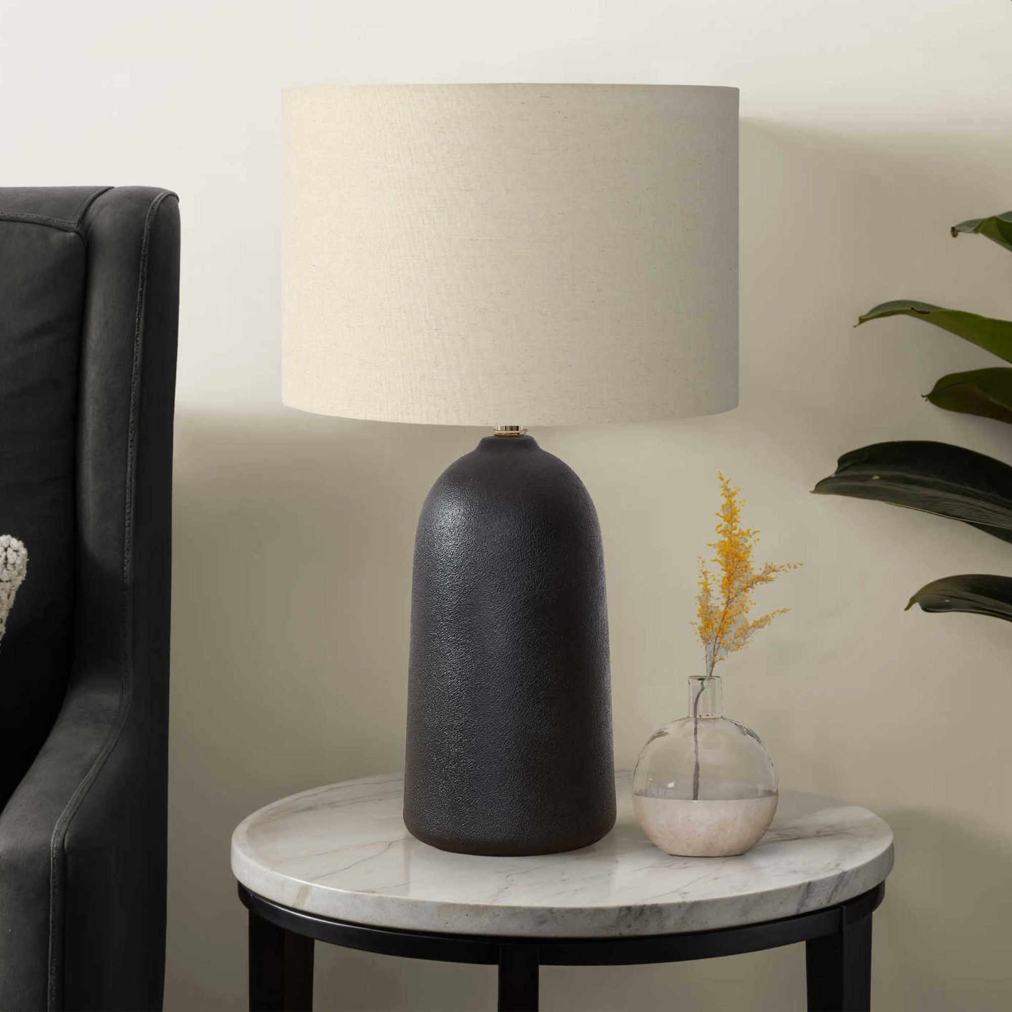 Black ceramic table lamp measuring 27 inches tall with a sleek design, ideal for modern home decor.