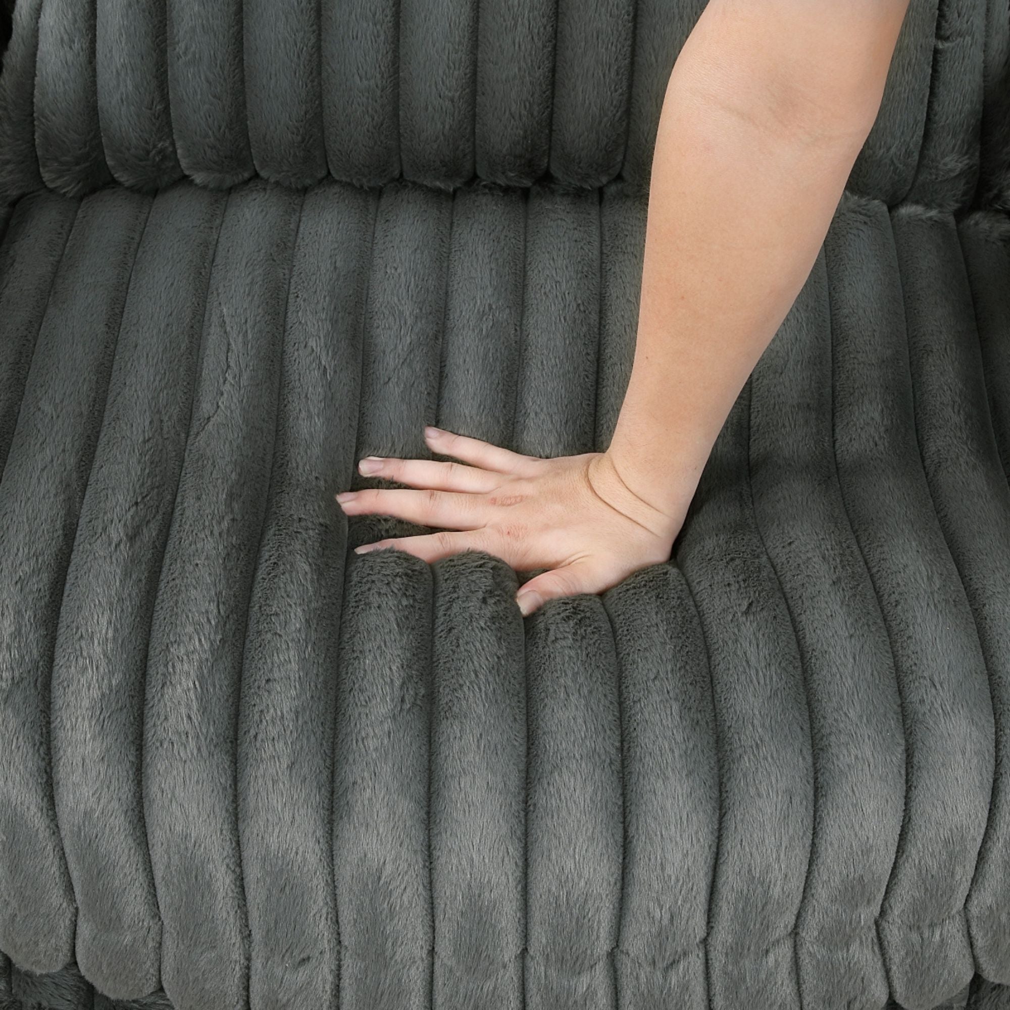 Dark grey Tomball accent chair by M.A.F with plush fabric and a modern design, shown in a stylish living room setting.