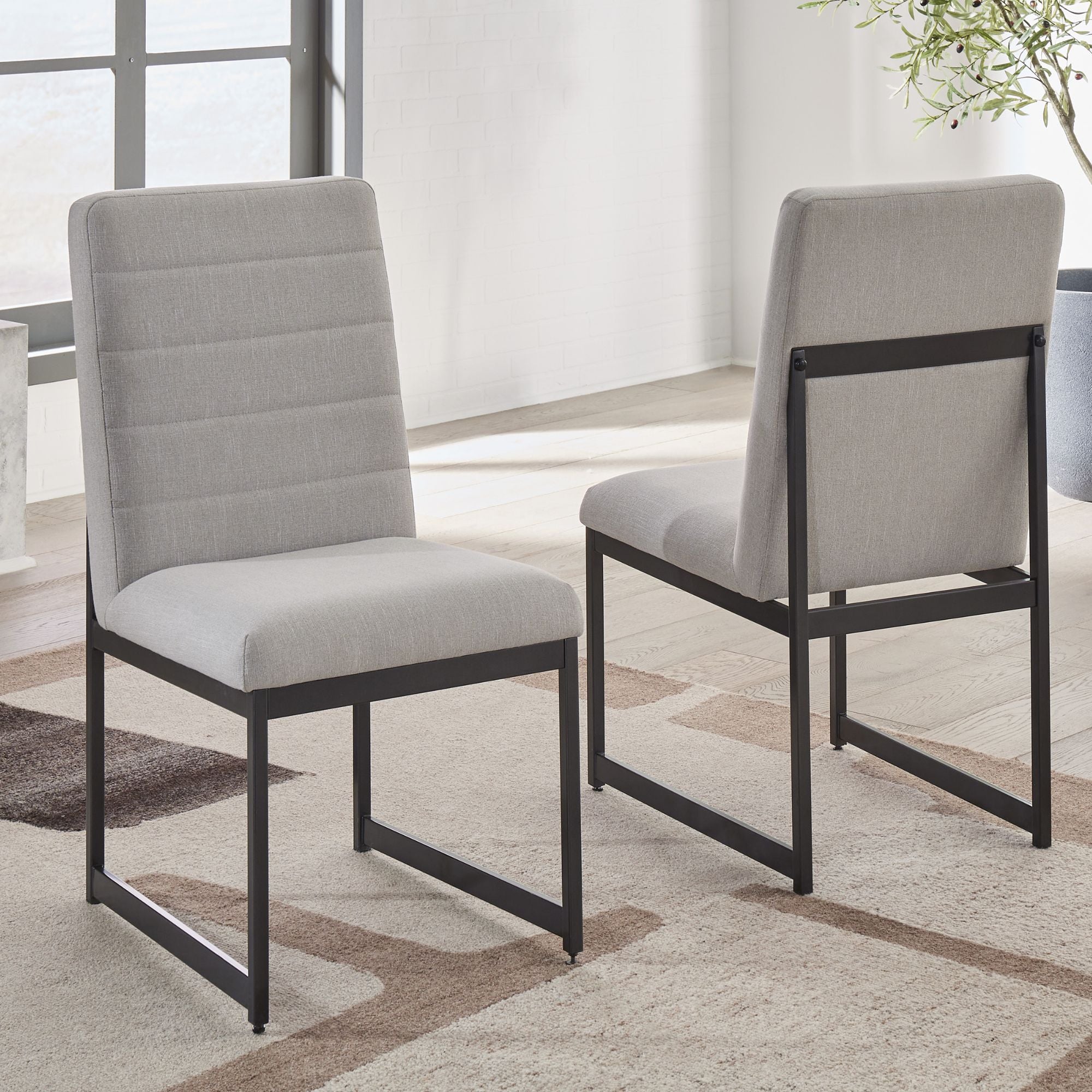 Grey Tomtyn dining room set by Signature Ashley featuring a table and matching chairs in a modern dining space.