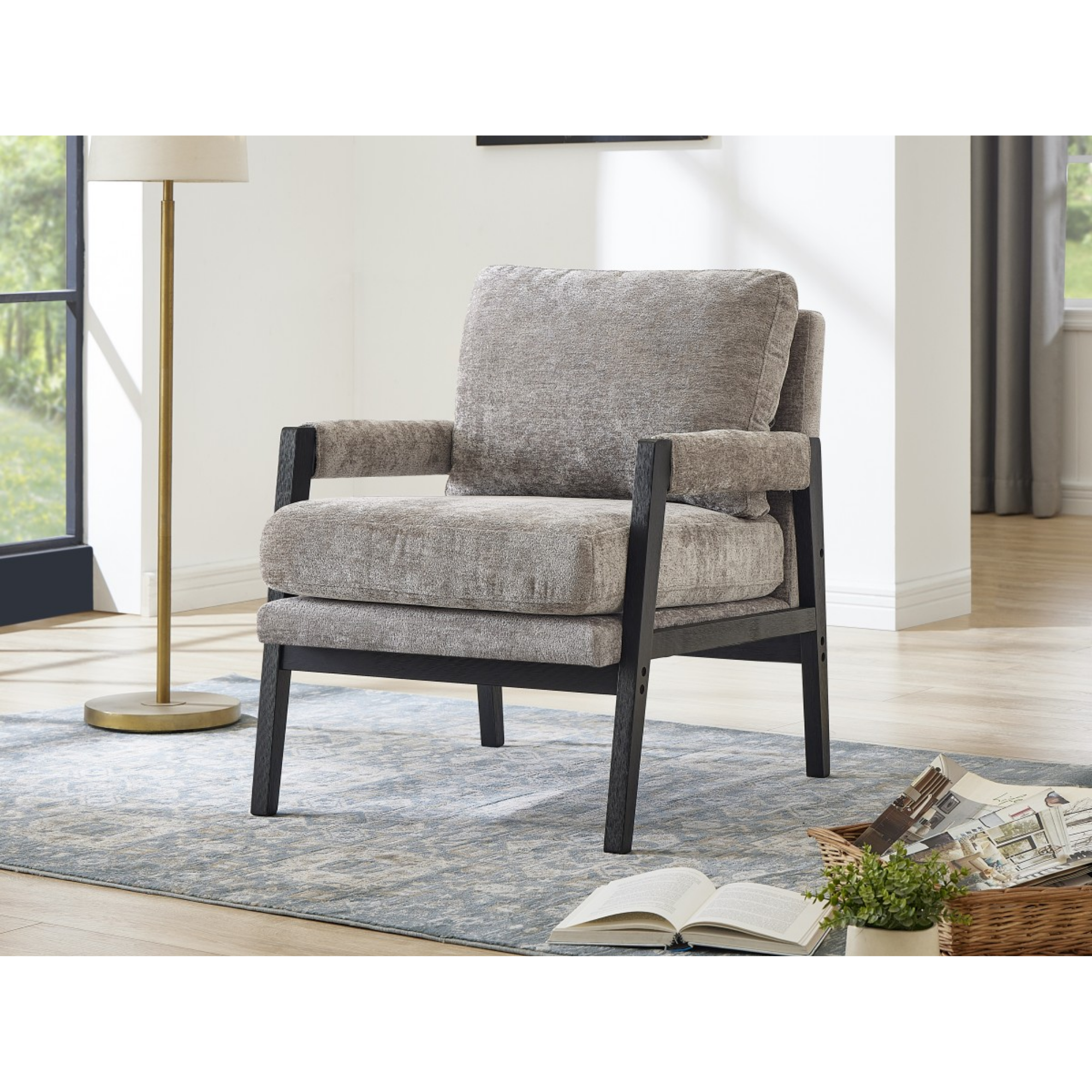 Grey fabric accent arm chair by Brassex with cushioned seat and curved armrests, modern design for living room or lounge.