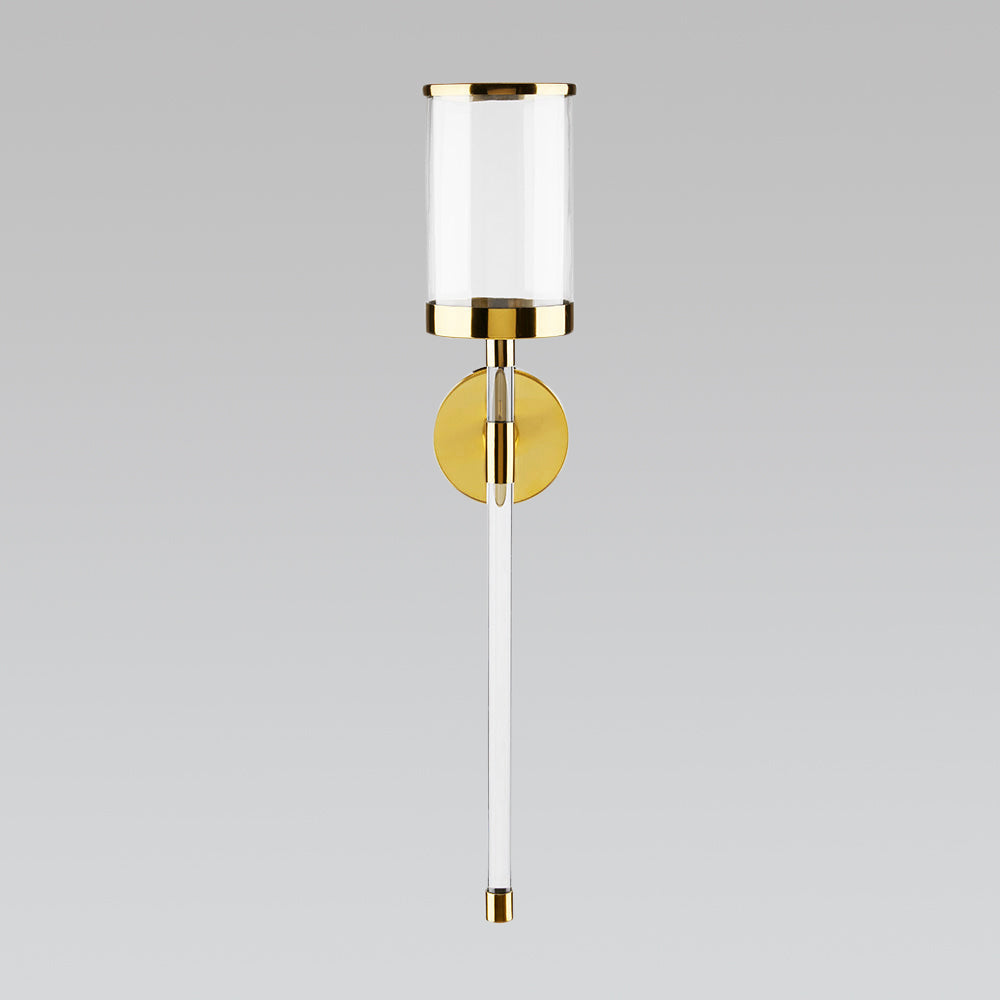 Gold acrylic wall sconce by Xcella, decorative wall light with modern design and sleek finish, mounted on a wall.