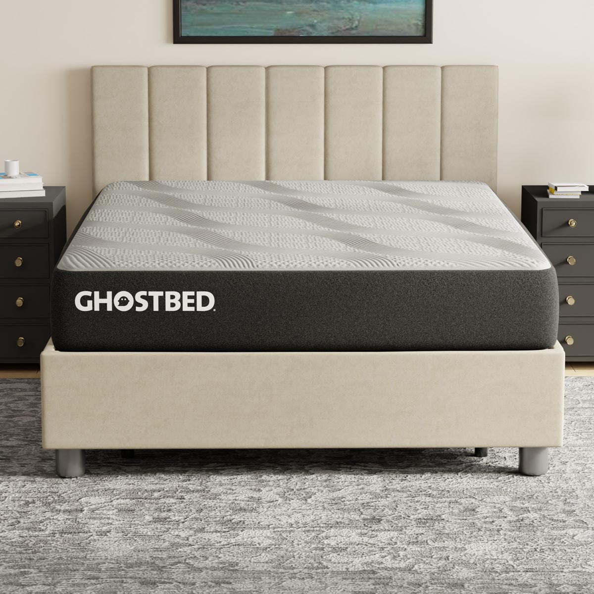 GhostBed Essential 11-inch foam mattress with a neutral-colored fabric cover, shown on a bed frame in a bedroom setting.