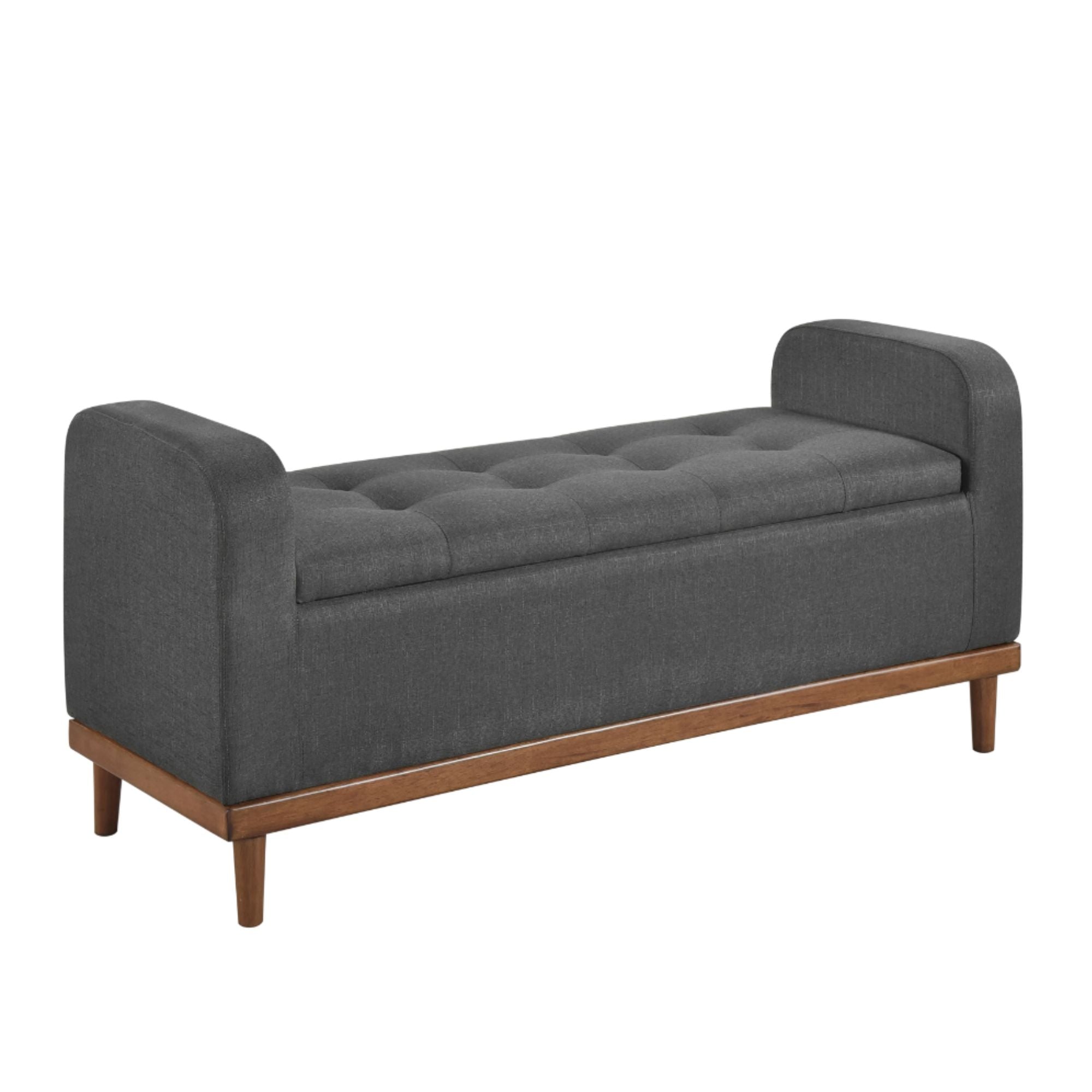 Dark grey MAZ Brigitte Collection lift top storage ottoman with fabric upholstery and spacious interior for versatile storage.