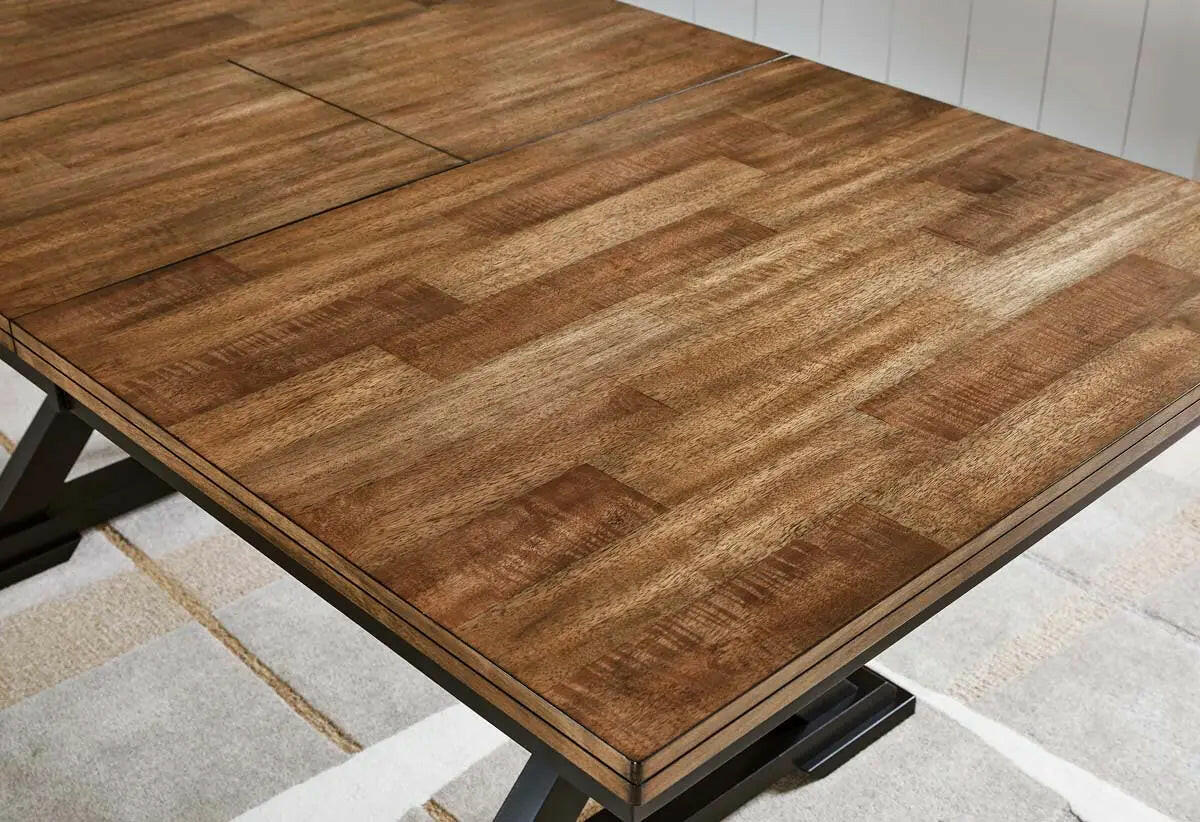 Close-up of the top detail of the Wildenauer RECT dining room table by Signature Design Ashley, showcasing its wood grain and rectangular shape.