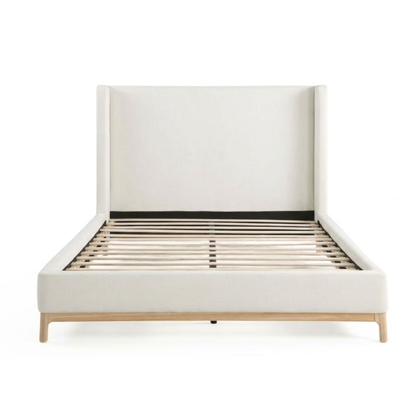 Brassex Serene upholstered platform bed with a padded headboard and neutral fabric, showcasing a modern bedroom design.