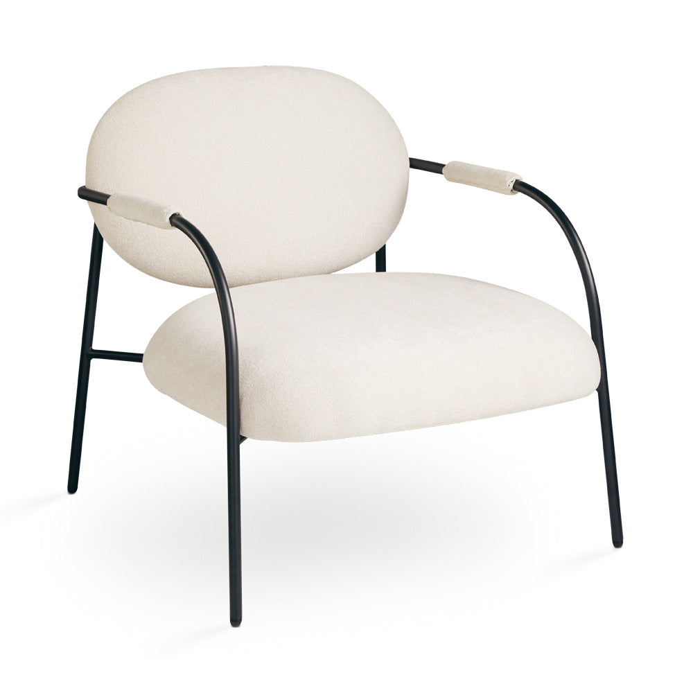 Xcella Alvin beige accent chair with wooden legs, three-quarter view showing modern design and plush upholstery.