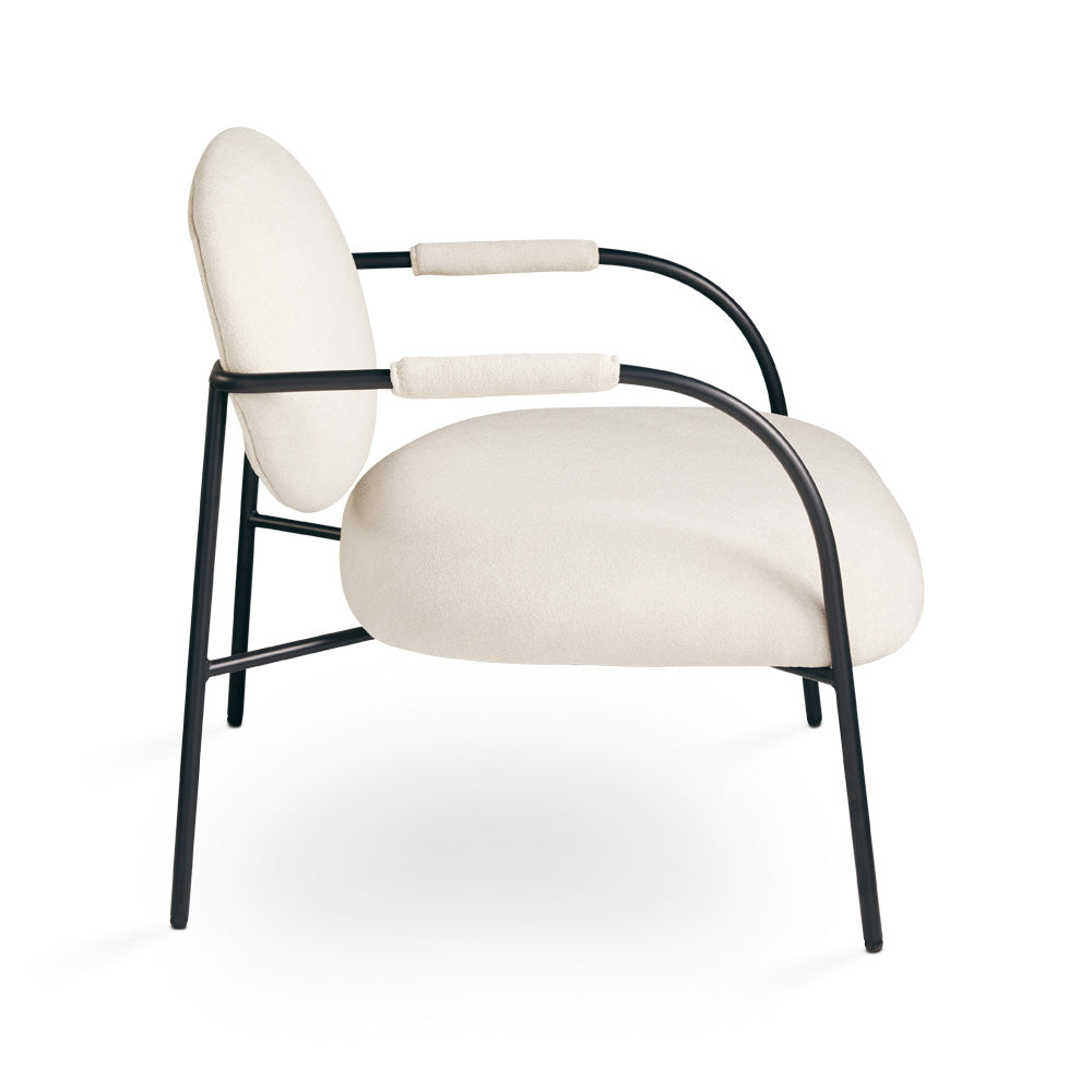 Xcella Alvin beige accent chair shown from the side, featuring a modern design and plush upholstery for stylish comfort.