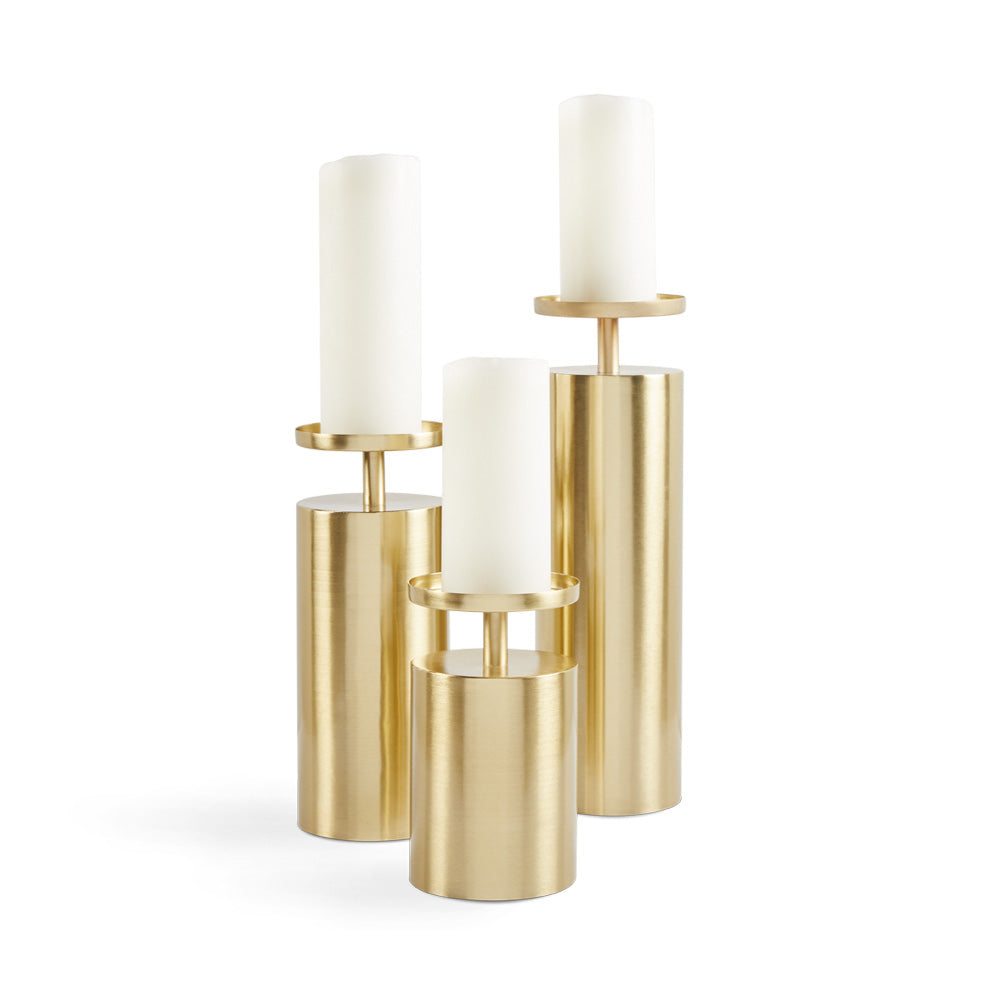 Set of three Raya candle holders by Xcella, featuring modern geometric design and various sizes for decorative candle display.