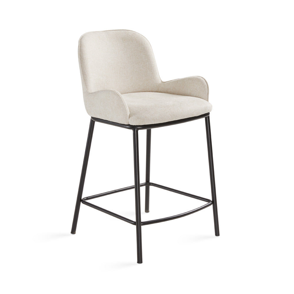 Grey linen Bennett counter stool by Xcella with wooden legs, shown from a three-quarter angle.