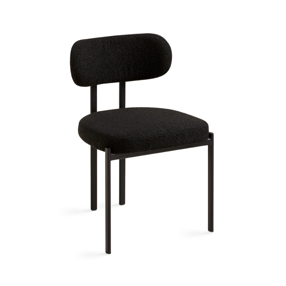 Xcella Otis dining chair with black boucle upholstery, modern design and sturdy wooden legs for stylish dining room seating.