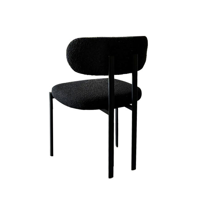 Xcella Otis black boucle dining chair with sleek side view, showcasing modern design and comfortable seating.