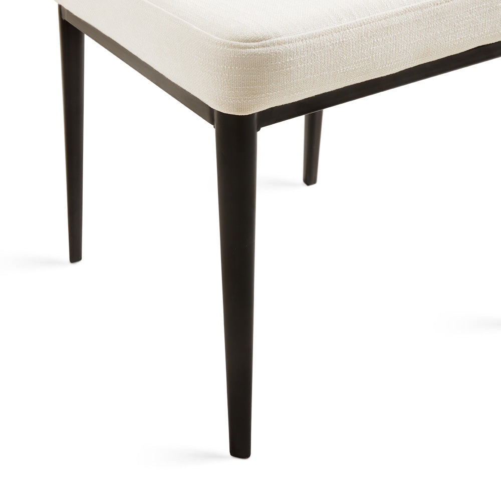 Set of two ivory shell-shaped dining chairs with linen upholstery and wooden legs by Xcella.