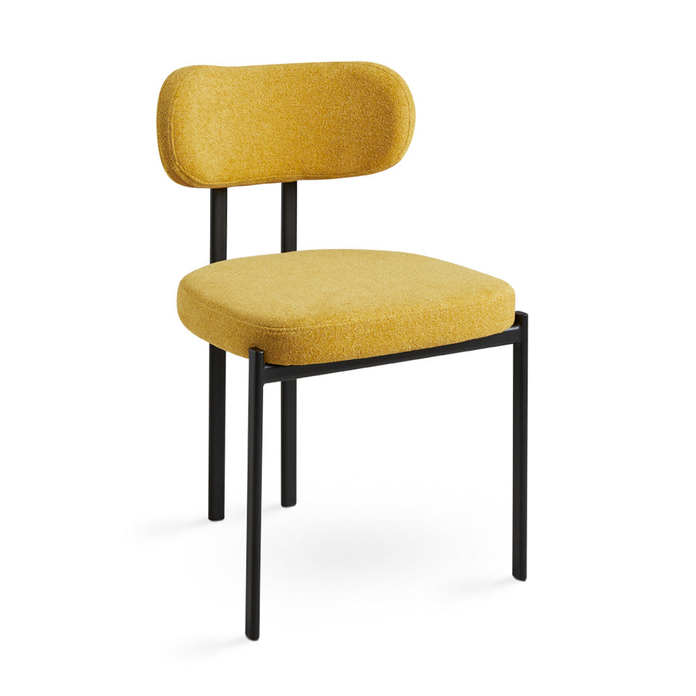 Xcella Otis yellow mustard dining chair with modern design, showcasing its sleek, upholstered seat and wooden legs.