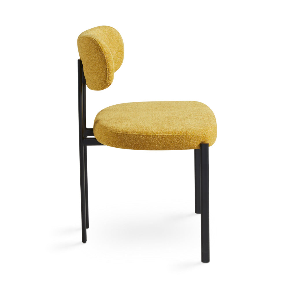 Yellow mustard Otis dining chair by Xcella with a modern design, shown from a side view highlighting its sleek shape.