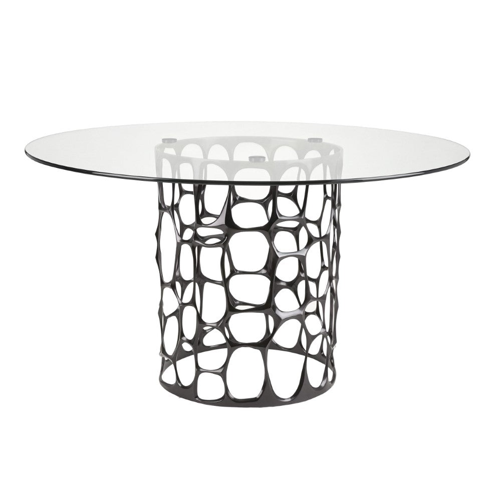 Black Mario dining table with glass top by Xcella, shown in a modern dining room setting with sleek design and sturdy legs.