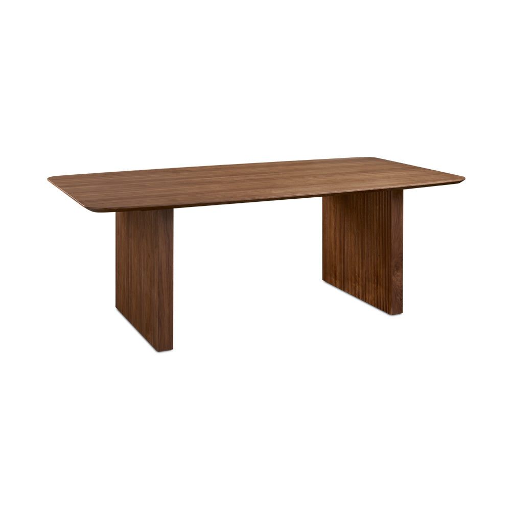 Xcella Pauline dining table with wooden top and sturdy legs, displayed as a floor model in a modern dining room setting.