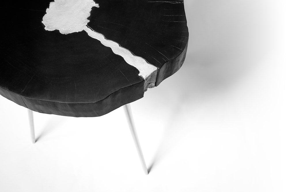 Black Xcella AKIS end table with a sleek modern design, featuring a smooth tabletop and sturdy metal legs.