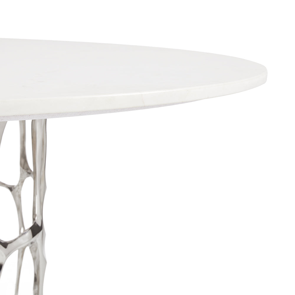 Xcella Mario marble dining table with silver base, showcasing its sleek edge and modern design for kitchen and dining spaces.