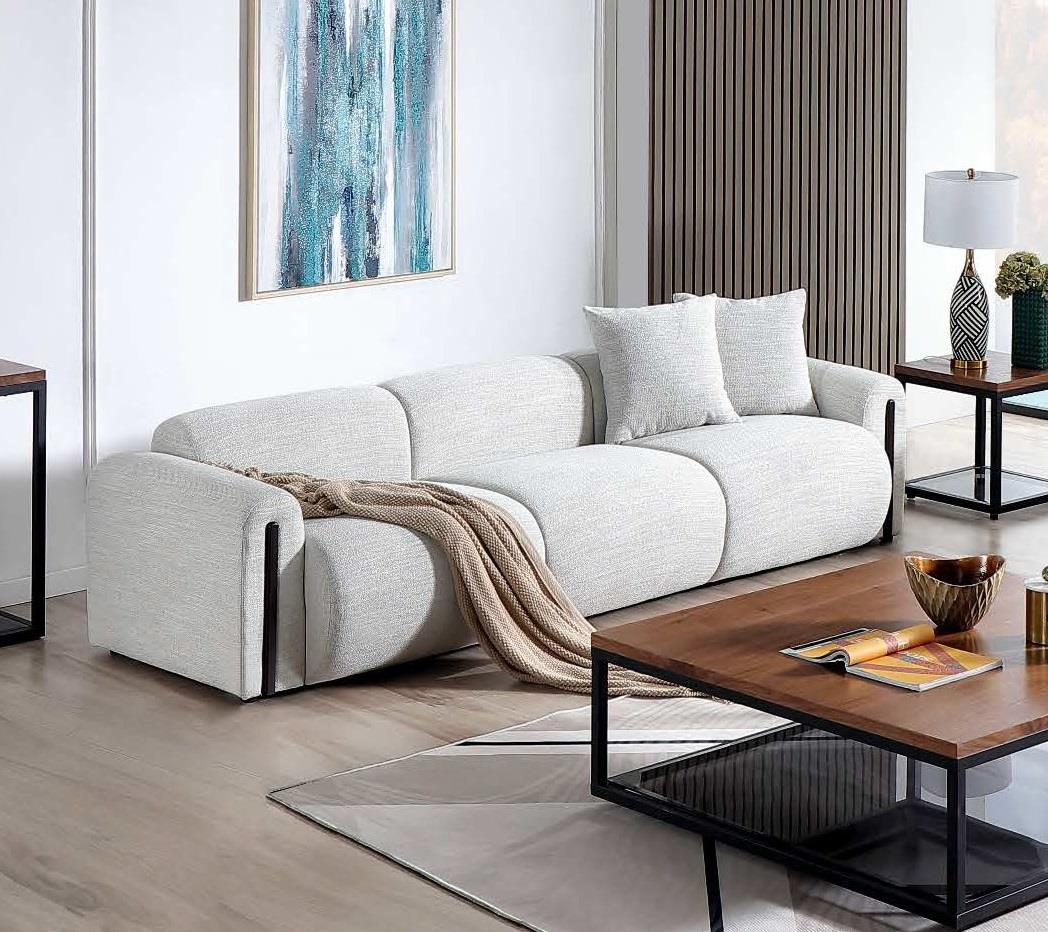 Xcella Designers Collection Brenton 4-seater sofa with plush cushions and modern design, shown in a stylish living room setting.